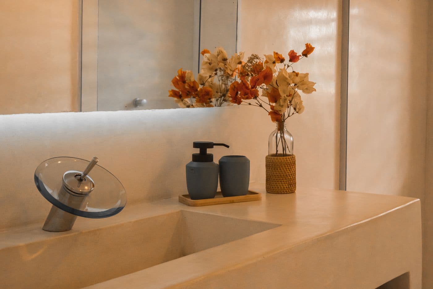 Warm minimalist bathroom sink and flowers